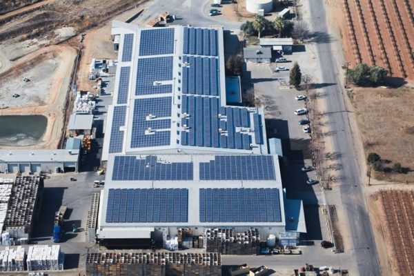 Aerial view of solar panels on rooftop of Visalia Citrus commercial building. 