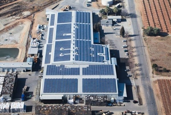 Aerial view of solar panels on rooftop of Visalia Citrus commercial building.