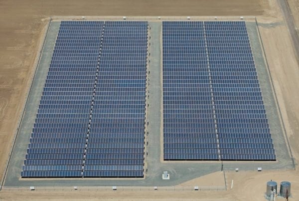 Aerial view of an agricultural solar installation on barren California farm land.