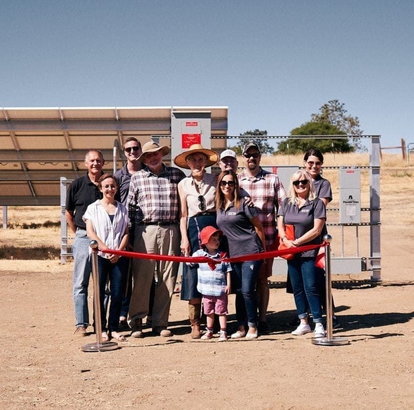 A group of employees from Citrona Farms in Winters, California standing at the ribbon cutting ceremony in front of their new solar system.