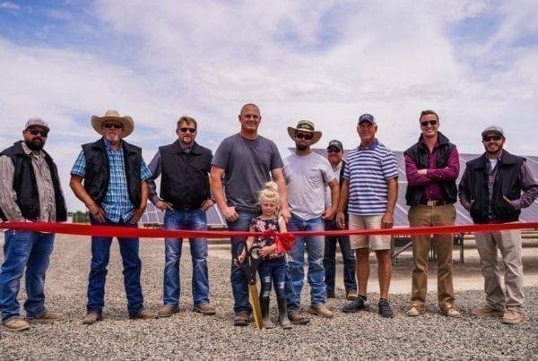 A group of employees from Johann Dairy in Fresno, California standing at the ribbon cutting ceremony in front of their new solar system.