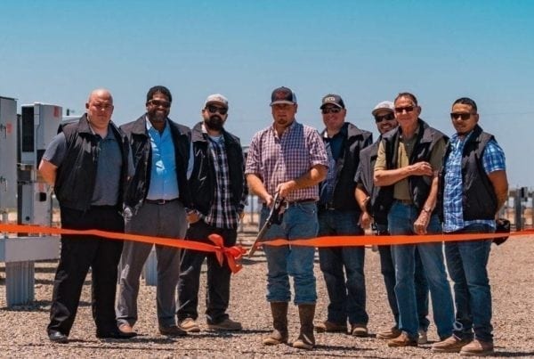A group of employees from Pedretti Ranch in El Nido, California standing at the ribbon cutting ceremony in front of their new solar system.