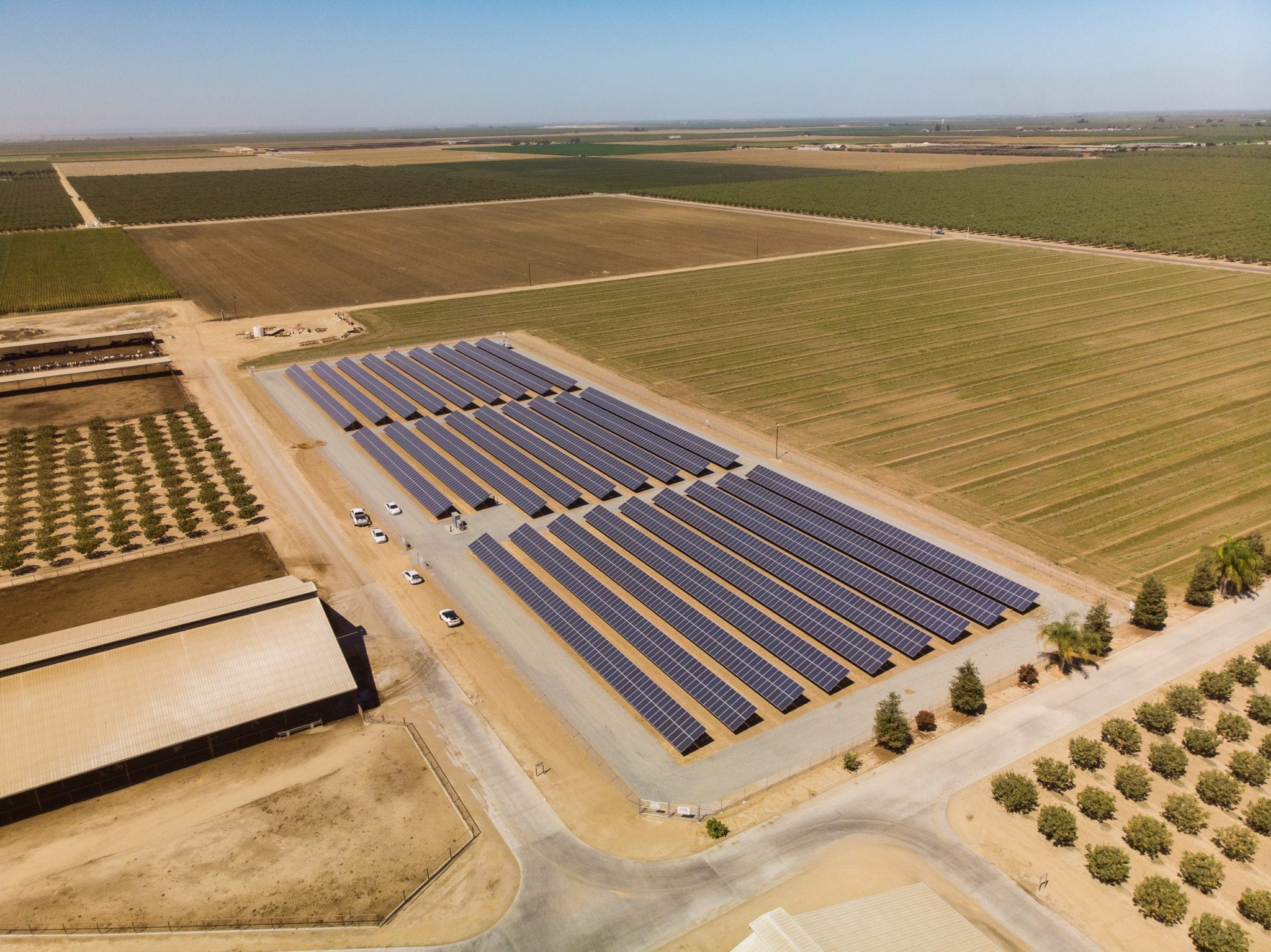 Aerial view of solar installation surrounded by crops and plowed farmland at Skyview Dairy in Shafter, California.