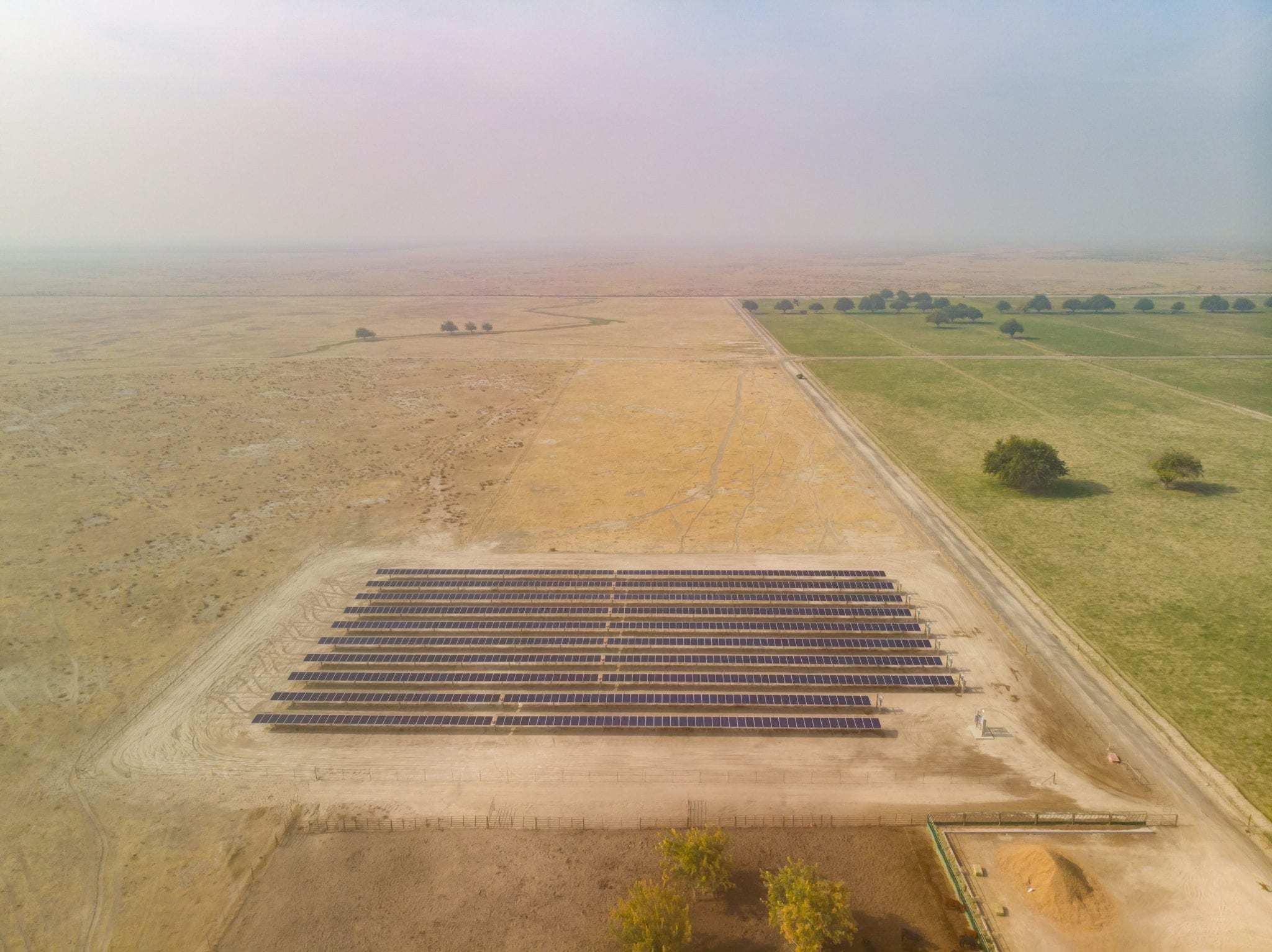 Aerial view of small solar farm on agricultural land in Madera, California.