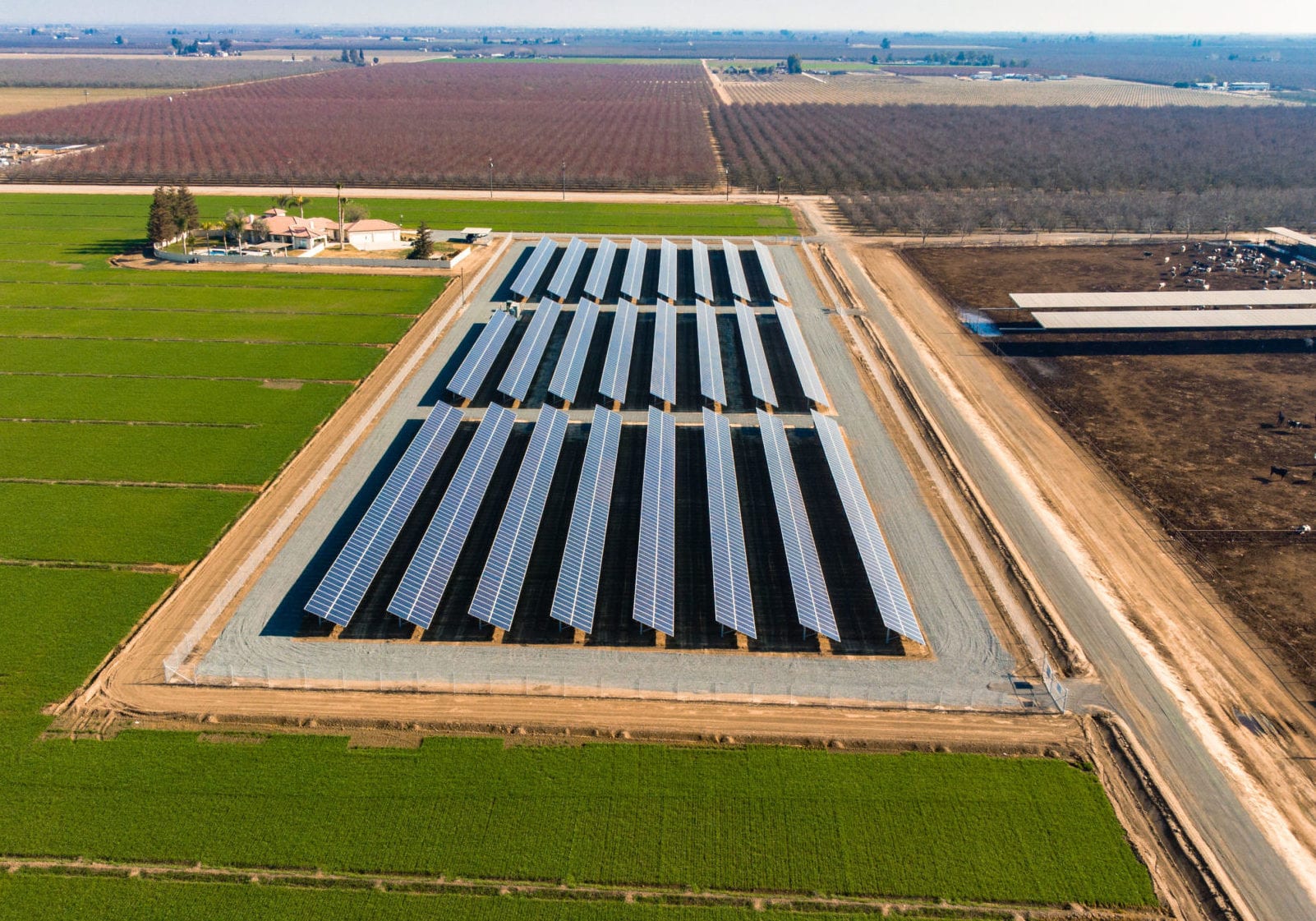 Aerial view of rows of solar panels on a solar farm in California's agriculture industry.