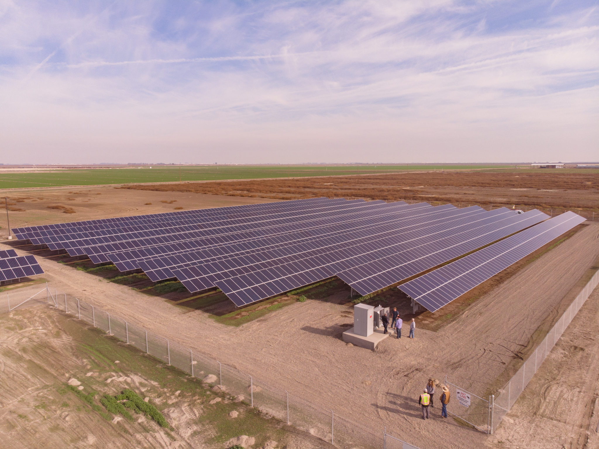 Aerial view of the solar installation surrounded by brown farmland at Lakeshore Dairy in Hanford, California.