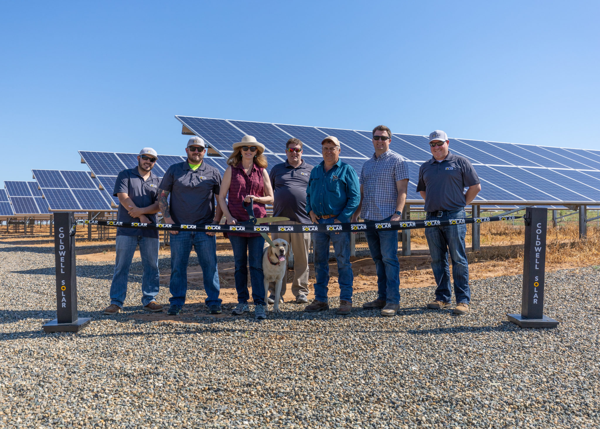 Employees standing in front of their new solar array in Gustine, California.
