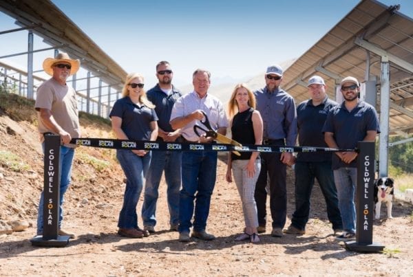 Employees standing at a ribbon cutting for a new solar installation in Porterville, California.