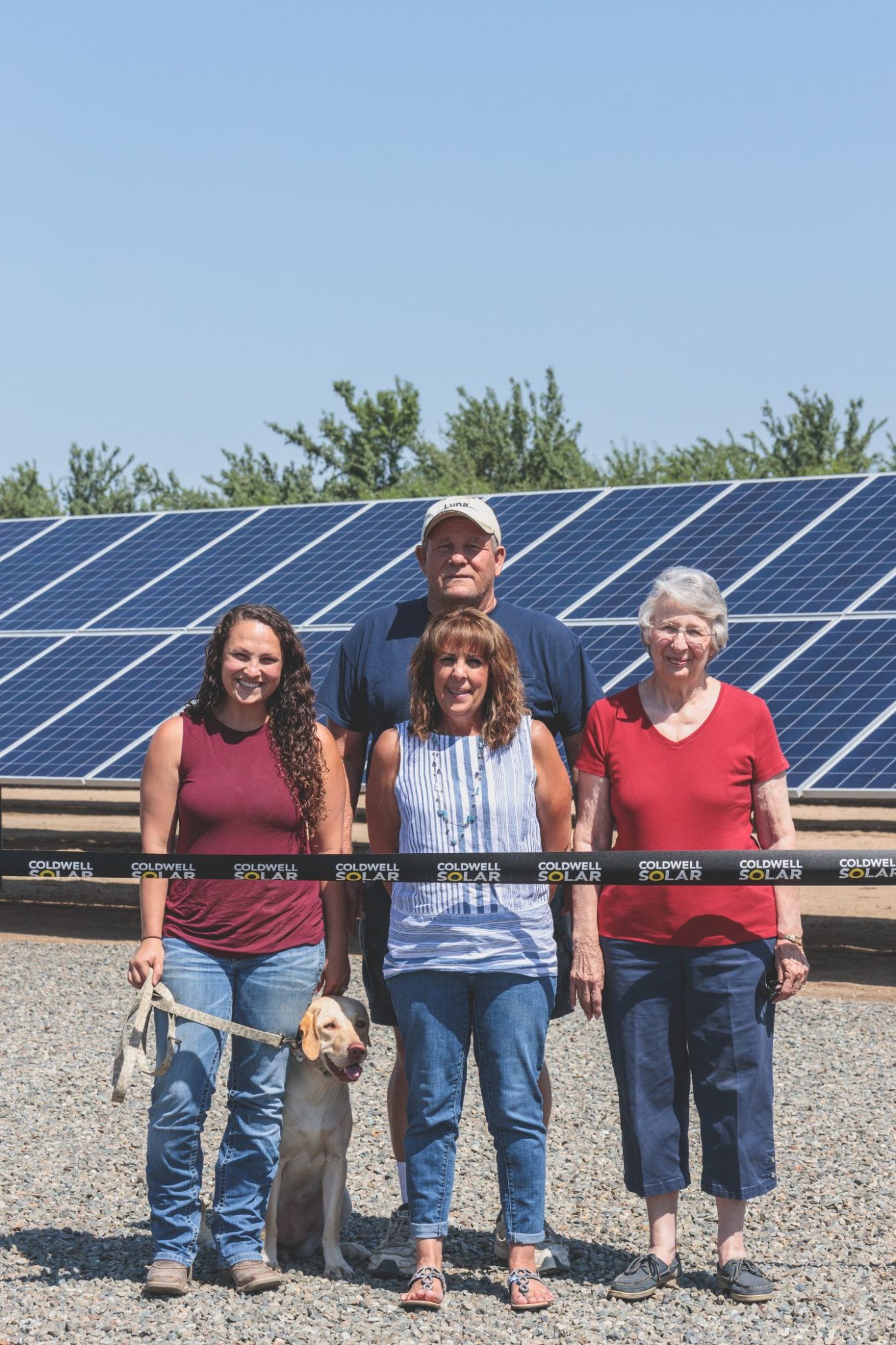 Machado Farms owners standing in front of the new solar array at the property in Fresno, California.