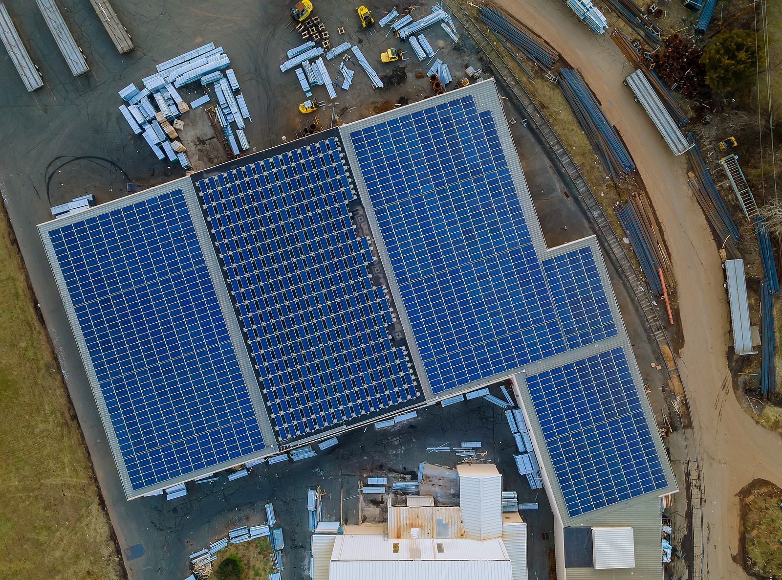 Aerial view of solar panels covering rooftop of a commercial building.