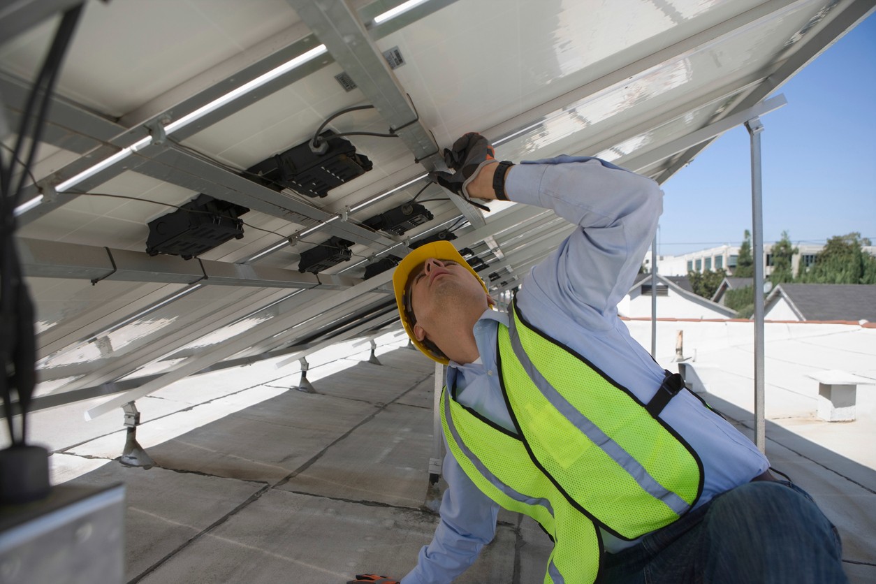 worker-repairing-solar-panels