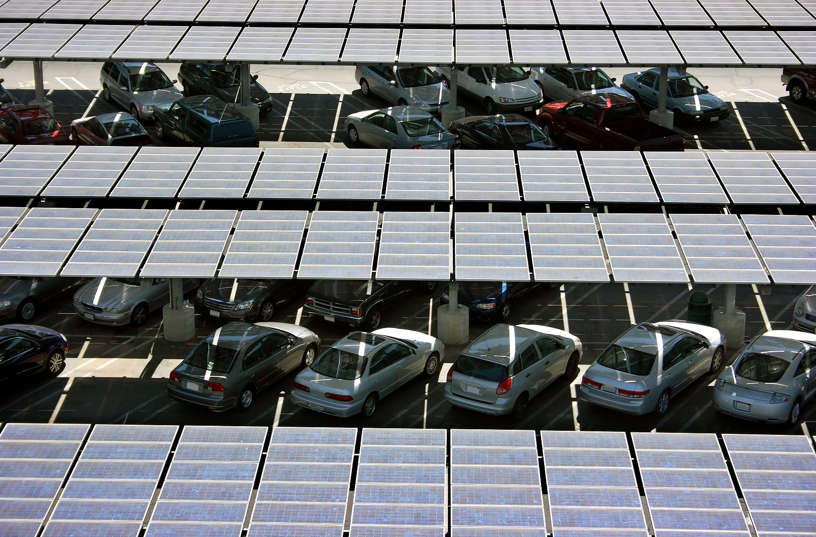 Solar energy carport in California with rows of cars parked underneath.