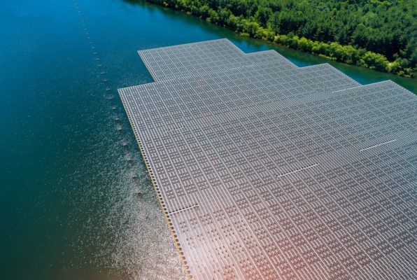 Aerial view of solar panels floating on water. 