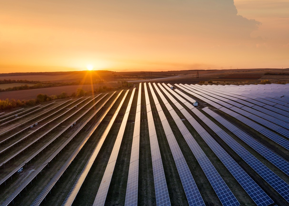 Sunset on blue solar panels at a solar farm in California.